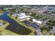 Aerial view showcases community center with pool, parking, and proximity to water at 1922 Sifield Greens Way # 47, Sun City Center, FL 33573