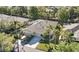 Aerial view of the property showcasing lush landscaping, mature trees, and a three car garage at 1922 Sifield Greens Way # 47, Sun City Center, FL 33573