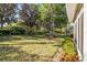 Well-maintained backyard with mature trees and green grass at 1922 Sifield Greens Way # 47, Sun City Center, FL 33573