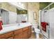 Well-lit bathroom features a glass shower and a long vanity with drawers at 1922 Sifield Greens Way # 47, Sun City Center, FL 33573