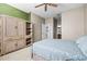 Light-filled bedroom with an ensuite bath and neutral tones, featuring a rattan armoire at 1922 Sifield Greens Way # 47, Sun City Center, FL 33573