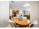 View of dining room featuring a wooden table and chairs adjacent to kitchen and living room at 1922 Sifield Greens Way # 47, Sun City Center, FL 33573