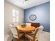 Cozy dining room featuring an oval table and four upholstered chairs with lots of natural light at 1922 Sifield Greens Way # 47, Sun City Center, FL 33573
