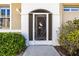 Close-up of the home's front entrance, featuring a decorative security door with a heron design at 1922 Sifield Greens Way # 47, Sun City Center, FL 33573