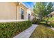 Attractive front exterior with well-maintained landscaping, walkway and a glimpse of an decorative front door at 1922 Sifield Greens Way # 47, Sun City Center, FL 33573