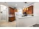 Well-equipped kitchen with warm wood cabinetry, stone tile backsplash, and a functional breakfast bar at 1922 Sifield Greens Way # 47, Sun City Center, FL 33573