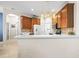 Modern kitchen featuring wooden cabinets, white countertops, and stainless steel appliances at 1922 Sifield Greens Way # 47, Sun City Center, FL 33573