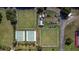 Aerial view of lawn bowling and shuffleboard courts with people enjoying recreational activities at 1922 Sifield Greens Way # 47, Sun City Center, FL 33573