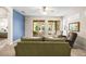 Bright living room featuring neutral carpeting, cozy seating, sliding glass doors, and a serene backyard view at 1922 Sifield Greens Way # 47, Sun City Center, FL 33573