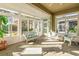 Sunroom filled with wicker furniture and natural light at 1922 Sifield Greens Way # 47, Sun City Center, FL 33573