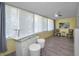 Entertainment area with a custom bar, counter seating, and ample natural light at 200 Glennes Ln # 201, Dunedin, FL 34698