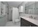 Bathroom featuring a toilet, sink, mirror, vanity, shower, and other fixtures at 200 Glennes Ln # 201, Dunedin, FL 34698