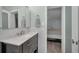 Modern bathroom with stylish vanity, sink, and mirror, opening into the bedroom at 200 Glennes Ln # 201, Dunedin, FL 34698