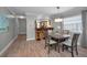 Bright and open dining room features updated flooring, and a view into the kitchen at 200 Glennes Ln # 201, Dunedin, FL 34698