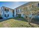 Well-maintained two-story building features lush landscaping and a pleasant facade at 200 Glennes Ln # 201, Dunedin, FL 34698