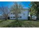 Charming two-story condo building featuring black shutters and well-maintained landscaping at 200 Glennes Ln # 201, Dunedin, FL 34698