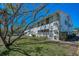 Exterior view of the building with well-maintained landscaping and ample shade at 200 Glennes Ln # 201, Dunedin, FL 34698