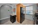 Spacious kitchen featuring a black stainless steel refrigerator and a practical kitchen island with a butcher block top at 200 Glennes Ln # 201, Dunedin, FL 34698