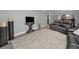 Open-concept living space showcasing neutral walls and a textured area rug at 200 Glennes Ln # 201, Dunedin, FL 34698