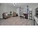 Bright living room featuring hard wood floors, ceiling fan, with cozy seating and a desk at 200 Glennes Ln # 201, Dunedin, FL 34698