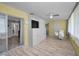 Bright living room with wood floors, built-in shelving, and a sliding door to the outside at 200 Glennes Ln # 201, Dunedin, FL 34698