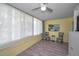Living room featuring hard wood floors, a ceiling fan, and lots of natural light at 200 Glennes Ln # 201, Dunedin, FL 34698