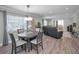 Open-concept living room featuring a dining area and comfortable seating with light gray colored walls at 200 Glennes Ln # 201, Dunedin, FL 34698