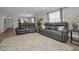 Spacious living room with stylish seating, neutral tones, and seamless flow with updated flooring at 200 Glennes Ln # 201, Dunedin, FL 34698