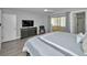 Main bedroom with gray decor, a ceiling fan, and access to a screened-in patio at 200 Glennes Ln # 201, Dunedin, FL 34698