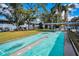 Community shuffleboard courts amidst lush greenery, ideal for active living at 200 Glennes Ln # 201, Dunedin, FL 34698