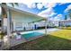 Community shuffleboard court with shaded seating and a carport on a bright sunny day with a blue sky at 200 Glennes Ln # 201, Dunedin, FL 34698