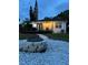 Backyard featuring stone fire pit, a walkway, patio, and manicured lawn, ideal for outdoor activities at 205 N Westland Ave, Tampa, FL 33606