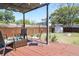 Well-kept backyard with a pergola-covered patio, storage shed, fire pit, and fenced perimeter at 205 N Westland Ave, Tampa, FL 33606