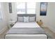 Bright bedroom with a gray headboard bed, white and gray bedding, and a large window with blinds at 205 N Westland Ave, Tampa, FL 33606