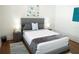 Comfortable bedroom featuring a gray bed frame, stylish bedding, and matching nightstands with lamps at 205 N Westland Ave, Tampa, FL 33606
