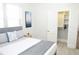 Bedroom featuring gray headboard bed, white and gray bedding, and view of an open closet at 205 N Westland Ave, Tampa, FL 33606