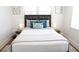 Bright bedroom showcasing a well-made bed with a beautiful decorative pillow and two side tables at 205 N Westland Ave, Tampa, FL 33606