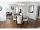 Elegant dining area with a glass table, modern chandelier, and seamless flow to living spaces at 205 N Westland Ave, Tampa, FL 33606