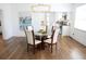 Dining area with modern chandelier and seamless flow into kitchen and living spaces at 205 N Westland Ave, Tampa, FL 33606
