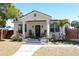 Charming single-story home featuring a welcoming porch with rocking chairs and well-maintained landscaping at 205 N Westland Ave, Tampa, FL 33606