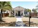 Inviting home with a lovely porch, complemented by a lush palm tree and a neat, green lawn at 205 N Westland Ave, Tampa, FL 33606