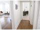 Hallway view to a living room with a white couch and a separate office space with a desk and chair at 205 N Westland Ave, Tampa, FL 33606