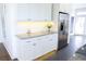 Kitchen with granite counters, stainless steel refrigerator, and white cabinets at 205 N Westland Ave, Tampa, FL 33606