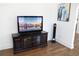 Living room features modern television console and decor with pristine hardwood flooring at 205 N Westland Ave, Tampa, FL 33606