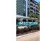 Turquoise 'Midtown' sign in front of an upscale apartment building with palm trees and colorful flower beds at 205 N Westland Ave, Tampa, FL 33606