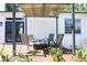 Outdoor patio area featuring a pergola, seating, and an entrance to the home at 205 N Westland Ave, Tampa, FL 33606