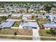 Neighborhood aerial view featuring a home with metal roof, fenced yard, and a sprawling community at 21298 Austin Ave, Port Charlotte, FL 33952