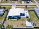 Aerial view of a cozy home with a patio set, shed, and fenced yard in a quiet neighborhood at 21298 Austin Ave, Port Charlotte, FL 33952