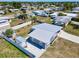 Aerial view showcasing a home with metal roof, a trailer behind the fence, and a well-kept lawn at 21298 Austin Ave, Port Charlotte, FL 33952
