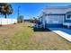 Green backyard with a white fence, an outdoor sink, patio and patio furniture at 21298 Austin Ave, Port Charlotte, FL 33952